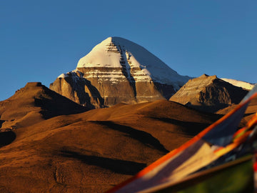Majestic Mount Kailash bathed in golden sunlight, sacred Himalayan peak symbolizing purity, devotion, and divine spiritual energy.