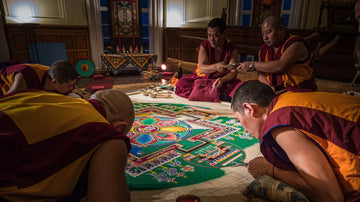 Tibetan monks create a colorful sand mandala with devotion and precision, representing spiritual balance and impermanence in Buddhist art.