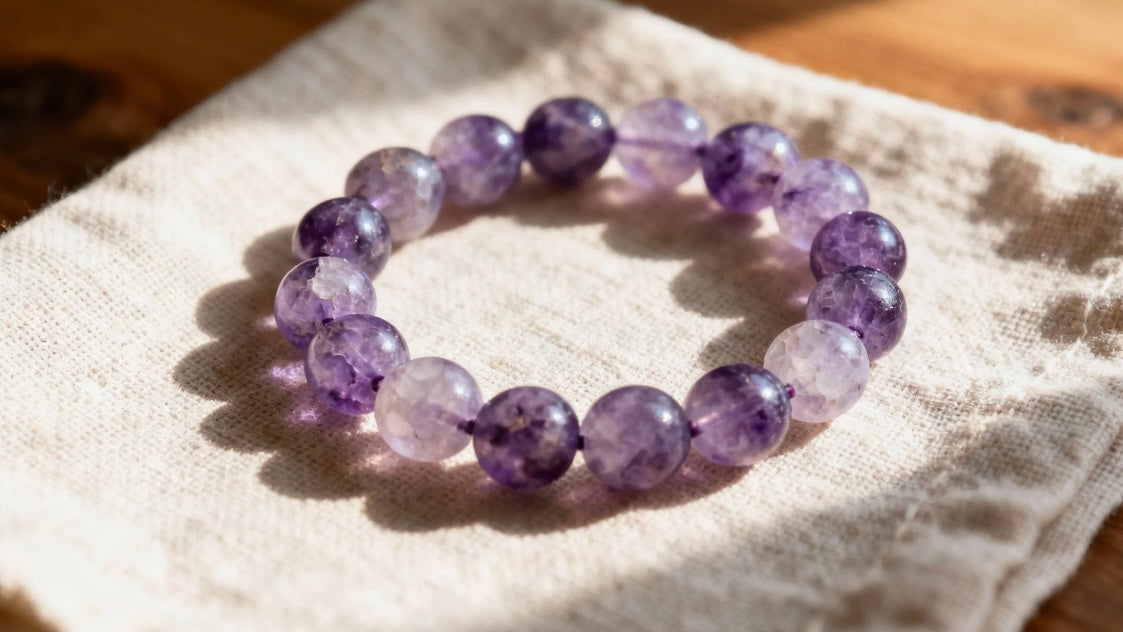 Amethyst feng shui bracelet on linen cloth under soft natural light, symbolizing calm, clarity, and balanced spiritual energy.