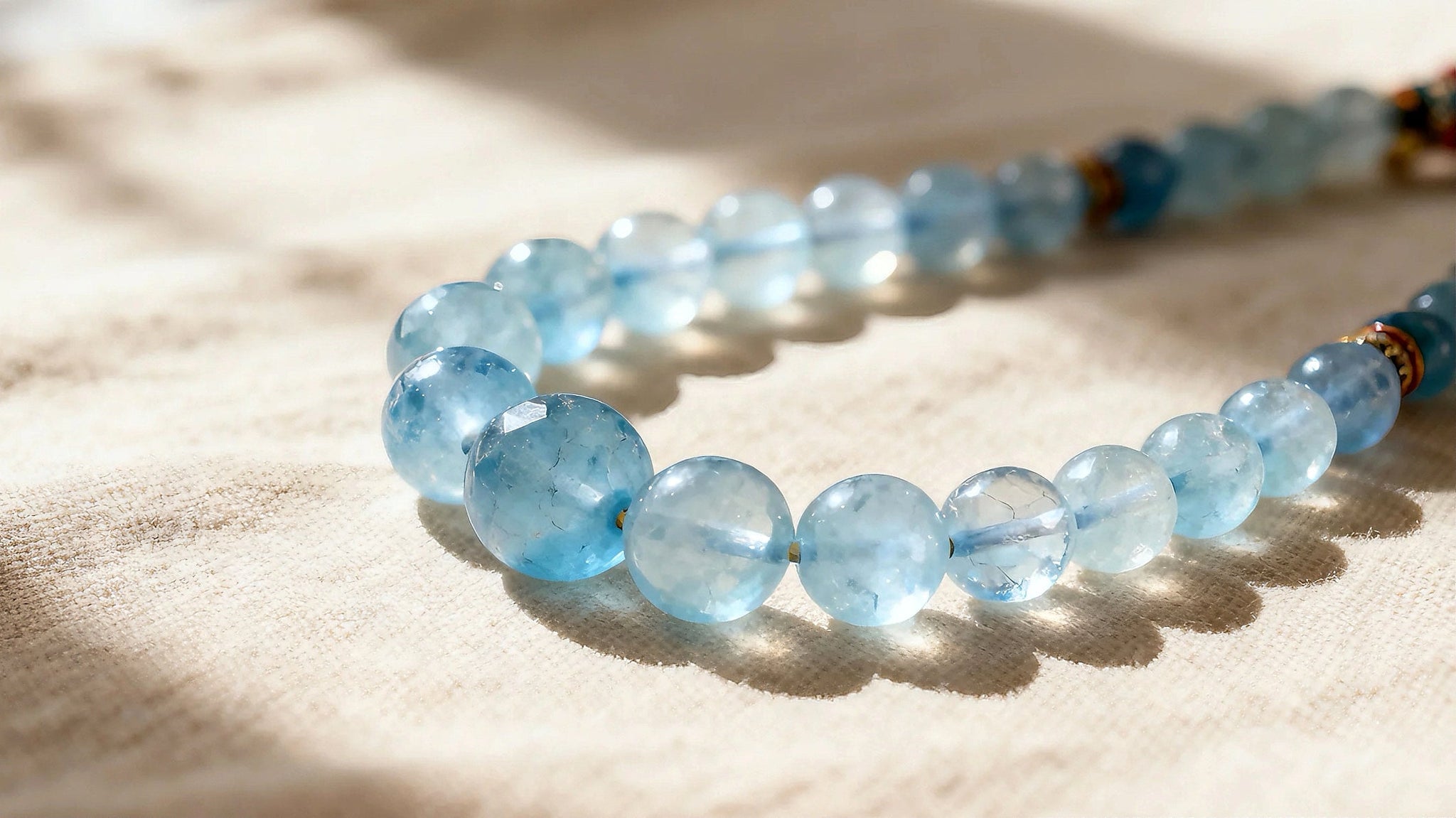 A handcrafted aquamarine bracelet glowing in soft natural light, showcasing its soothing blue color and artisanal details.
