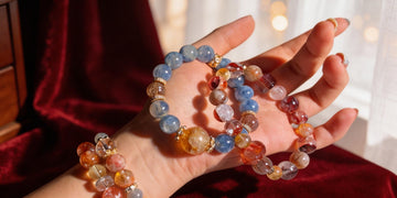 Natural crystal jewelry and handmade bracelets displayed on a textured surface, highlighting material purity, craftsmanship, and quiet luxury.